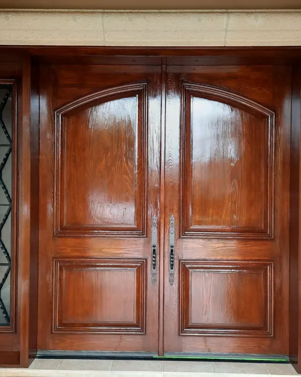 Dark mahogany entry door with matching sidelights after refinishing