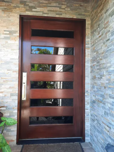 Mahogany entry door with stone surround