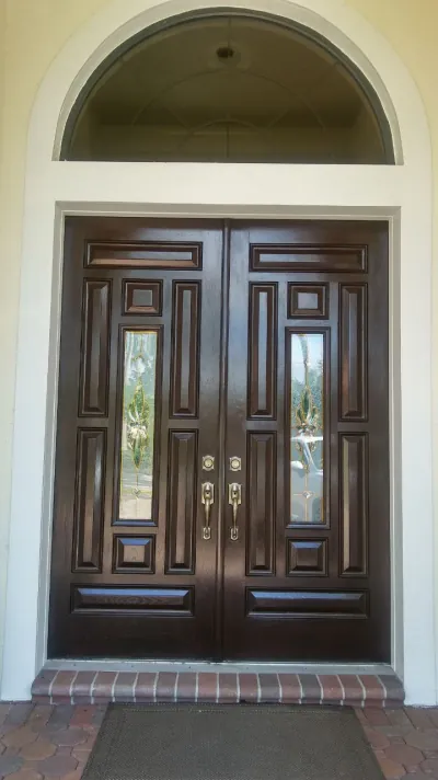 Dark-stained double entry doors with leaded glass panels