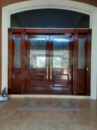 Dark mahogany entry door refinished at Laurel Oaks
