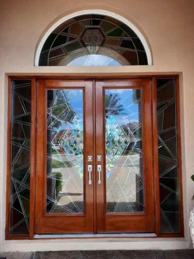 Mahogany double entry doors with leaded-glass sidelights and arched fanlight, refinished in Venice